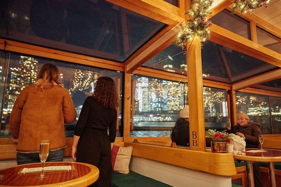 Boston: Harbor Sunset Yacht Cruise - Boston lights appearing across the water