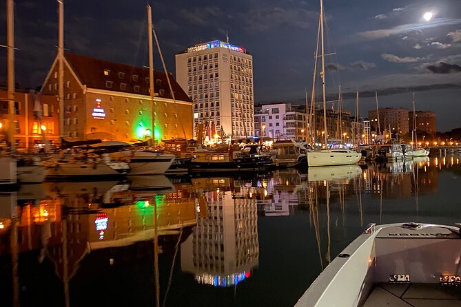 Gdansk: Scenic Evening Yacht Cruise with Welcome Drink - The Crane and Granary Island after dark
