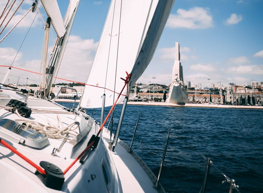 Lisbon: Yacht Sailing Tour With Portuguese Wine and History - Returning past Baixa and Praça do Comércio