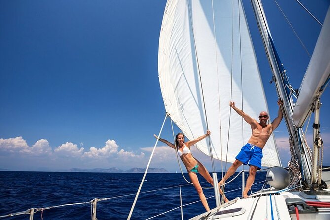 Santorini: Private Sailing Yacht Cruise with Meal and Drinks - The lighthouse and the volcano’s sulfur springs