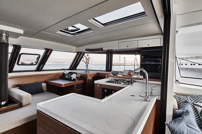 Santorini Private Tour Half-Day Sailing Platinum Catamaran Cruise - Oia from the sea, with a sunset detail to confirm